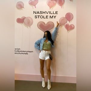 Light green knit tank. Tie detail. Cropped fit.